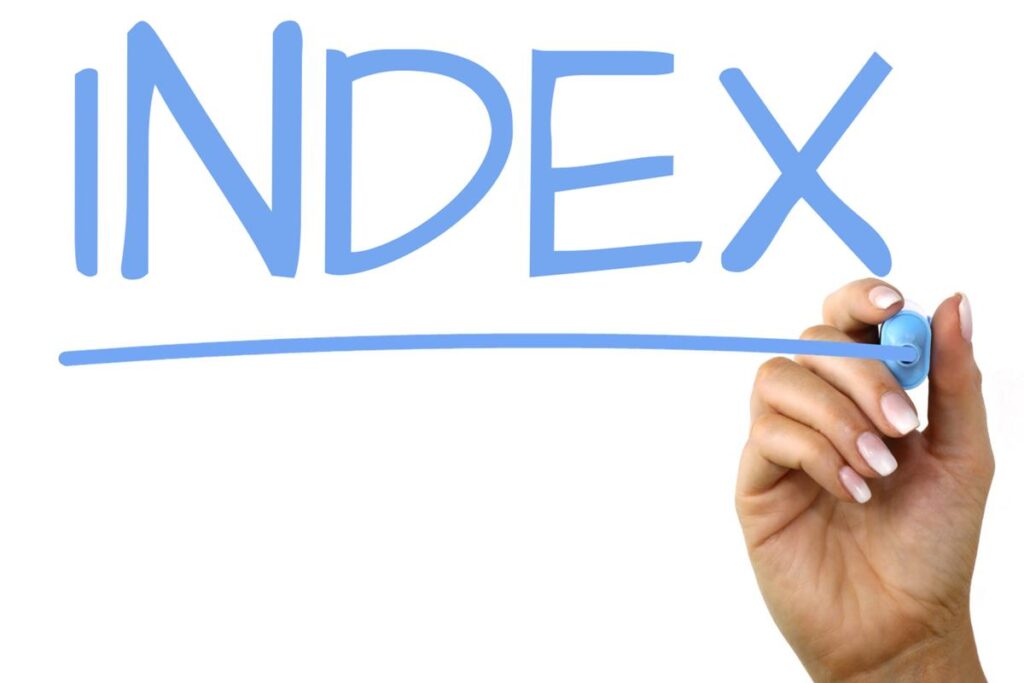 someone's hand writing the word "index"